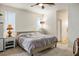 Bedroom with neutral-toned comforter, carpet, ceiling fan and ensuite bathroom access at 1000 E Sunset Rd, Henderson, NV 89011