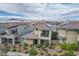 Inviting two-story home featuring a charming balcony, low maintenance landscaping, and mountain views at 1000 E Sunset Rd, Henderson, NV 89011