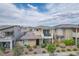 Inviting two-story home featuring a charming balcony, low maintenance landscaping, and mountain views at 1000 E Sunset Rd, Henderson, NV 89011