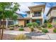 Beautiful two-story home with a balcony, desert landscaping, and a well-maintained front yard at 1000 E Sunset Rd, Henderson, NV 89011