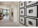 Inviting hallway featuring Gathering photos, neutral walls and carpet, and an inviting view to the outside at 1000 E Sunset Rd, Henderson, NV 89011