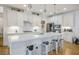 Bright kitchen featuring a spacious island with white quartz countertops and pendant lighting at 1000 E Sunset Rd, Henderson, NV 89011
