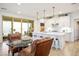 Bright kitchen with a large island and pendant lighting, connecting to a dining and living space at 1000 E Sunset Rd, Henderson, NV 89011