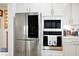 Stainless steel appliances, including a modern refrigerator and built-in oven/microwave at 1000 E Sunset Rd, Henderson, NV 89011