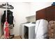 Laundry room with dark wood cabinets and white washer/dryer units at 1000 E Sunset Rd, Henderson, NV 89011