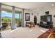 Spacious living room features large glass doors, carpet floors, and a scenic view of the surrounding landscape at 1000 E Sunset Rd, Henderson, NV 89011
