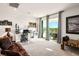 Spacious living room features large glass doors, carpet floors, and a scenic view of the surrounding landscape at 1000 E Sunset Rd, Henderson, NV 89011