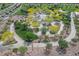 Aerial view featuring a beautifully landscaped park with walking paths, lush trees, and various amenities at 1000 E Sunset Rd, Henderson, NV 89011
