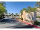 Entrance to the Chateau Nouveau community surrounded by lush palm trees and vibrant landscaping at 10001 Peace Way # 2228, Las Vegas, NV 89147