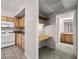 Cozy kitchen featuring wood cabinets, tile floors, and an adjacent built-in desk area at 10001 Peace Way # 2228, Las Vegas, NV 89147
