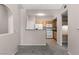 Eat-in kitchen featuring oak cabinetry, white appliances, and tile flooring at 10001 Peace Way # 2228, Las Vegas, NV 89147