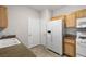 Kitchen with white appliances and wooden cabinets at 10001 Peace Way # 2228, Las Vegas, NV 89147
