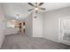 Bright living room featuring neutral walls, gray carpeting, and a ceiling fan at 10001 Peace Way # 2228, Las Vegas, NV 89147
