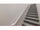 Carpeted staircase with white banister leading upstairs in this beautifully designed home at 10001 Peace Way # 2228, Las Vegas, NV 89147