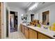 Spacious bathroom featuring dual sinks, cabinets, mirrors, and tile flooring at 1048 Painted Daisy Ave, Henderson, NV 89074