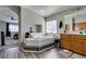 Bright bathroom with garden tub, wood-look floors, and large vanity area at 1048 Painted Daisy Ave, Henderson, NV 89074