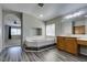 Bright primary bathroom featuring a soaking tub, wood cabinets, and gray wood-look floors at 1048 Painted Daisy Ave, Henderson, NV 89074