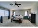 Comfortable carpeted bedroom with a ceiling fan and natural light from the windows at 1048 Painted Daisy Ave, Henderson, NV 89074