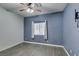 Bedroom with wood-look flooring, ceiling fan, a window, and neutral paint at 1048 Painted Daisy Ave, Henderson, NV 89074