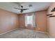 Cozy bedroom with neutral carpet, ceiling fan, and a window for natural light at 1048 Painted Daisy Ave, Henderson, NV 89074