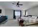 Spacious carpeted bedroom featuring a ceiling fan and plenty of natural light at 1048 Painted Daisy Ave, Henderson, NV 89074
