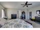 Spacious carpeted bedroom featuring a ceiling fan and plenty of natural light at 1048 Painted Daisy Ave, Henderson, NV 89074