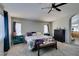 Bright bedroom with neutral walls, ceiling fan, and natural light from the windows at 1048 Painted Daisy Ave, Henderson, NV 89074