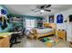 Bedroom with desk, shelving, and a large window at 1048 Painted Daisy Ave, Henderson, NV 89074