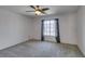 Spacious bedroom with ceiling fan, neutral carpet and a window overlooking the neighborhood at 1048 Painted Daisy Ave, Henderson, NV 89074