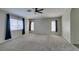 Large bonus room features neutral carpet and bright windows with neighborhood views at 1048 Painted Daisy Ave, Henderson, NV 89074