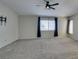 Neutral bonus room with carpeting, ceiling fan, windows, and a TV wall mount at 1048 Painted Daisy Ave, Henderson, NV 89074