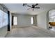 Bright bonus room with carpet, ceiling fan, and a view through the windows at 1048 Painted Daisy Ave, Henderson, NV 89074