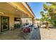 Inviting covered patio with comfortable seating, ceiling fan, and convenient outdoor entertainment space at 1048 Painted Daisy Ave, Henderson, NV 89074