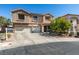Charming two-story home features a three-car garage and desert rock landscaping at 1048 Painted Daisy Ave, Henderson, NV 89074