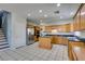 Spacious kitchen features wooden cabinets, granite countertops, tile flooring, and stainless steel appliances at 1048 Painted Daisy Ave, Henderson, NV 89074