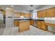 Spacious kitchen features wooden cabinets, granite countertops, tile flooring, and stainless steel appliances at 1048 Painted Daisy Ave, Henderson, NV 89074