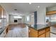 Spacious kitchen features wooden cabinets, granite countertops, tile flooring, and center island at 1048 Painted Daisy Ave, Henderson, NV 89074