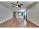 Spacious living room featuring wood floors, a ceiling fan, and natural light at 1048 Painted Daisy Ave, Henderson, NV 89074