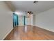 Bright living room with wood floors, ceiling fan, and large windows with coverings at 1048 Painted Daisy Ave, Henderson, NV 89074