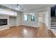A charming living room features hardwood floors, stairs and a fireplace at 1048 Painted Daisy Ave, Henderson, NV 89074