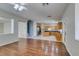 Hardwood floors seamlessly connect the living room to the modern kitchen area at 1048 Painted Daisy Ave, Henderson, NV 89074
