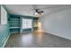Inviting living room with stylish built-in shelves, window, and wood-style flooring at 1048 Painted Daisy Ave, Henderson, NV 89074