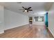 Large living room with beautiful hardwood floors, ceiling fan, and neutral wall paint at 1048 Painted Daisy Ave, Henderson, NV 89074
