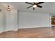 Open-concept living area featuring hardwood floors, ceiling fans and neutral wall paint at 1048 Painted Daisy Ave, Henderson, NV 89074