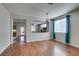 Open living room with wood floors, access to the kitchen, and ample natural light at 1048 Painted Daisy Ave, Henderson, NV 89074