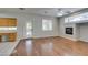 Bright living room boasts a fireplace, ceiling fan and wood-look floors at 1048 Painted Daisy Ave, Henderson, NV 89074