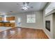 Open concept living room and kitchen feature hardwood floors and stainless appliances at 1048 Painted Daisy Ave, Henderson, NV 89074