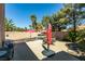 Backyard showcasing a pool, patio furniture, palm trees, and privacy wall at 1048 Painted Daisy Ave, Henderson, NV 89074