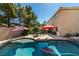 Enjoyable backyard pool area with seating and lush landscaping, perfect for summer fun at 1048 Painted Daisy Ave, Henderson, NV 89074