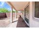 Relaxing back porch, including brick floors and a view of the backyard at 10713 Noble Mesa Ave, Las Vegas, NV 89166